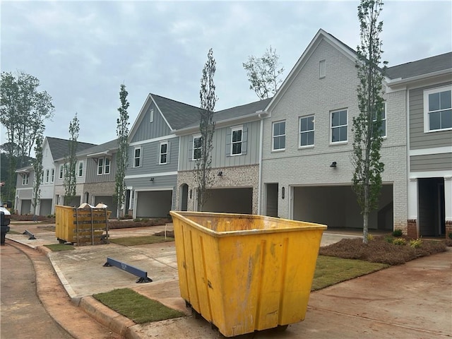 exterior space with a residential view, board and batten siding, and an attached garage