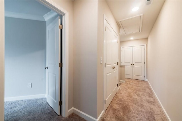 corridor featuring recessed lighting, baseboards, carpet, and attic access