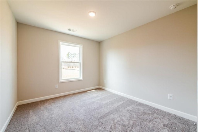 carpeted empty room with baseboards and visible vents