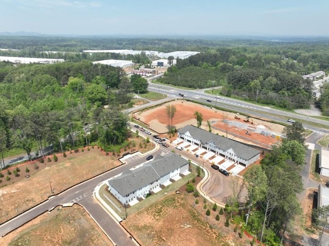 drone / aerial view with a wooded view