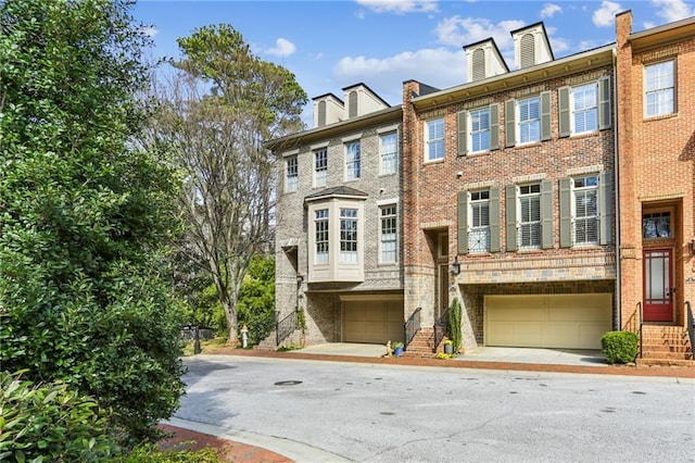 view of property featuring brick siding and an attached garage