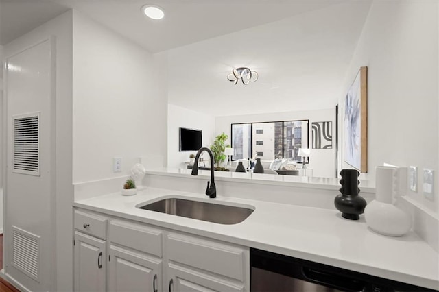 kitchen featuring white cabinetry, sink, and dishwasher