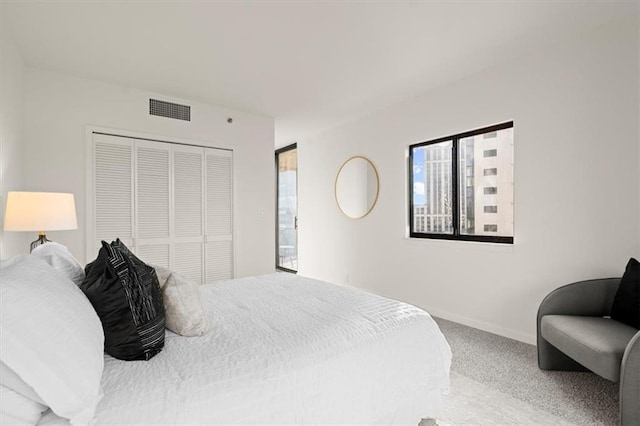 carpeted bedroom with a closet