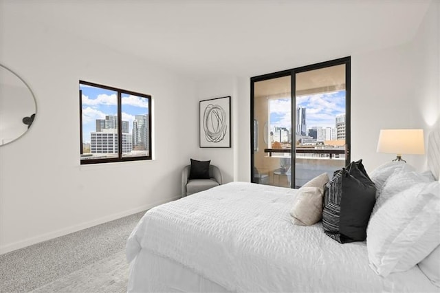 bedroom with carpet, access to exterior, and multiple windows