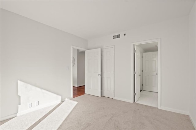 unfurnished bedroom with a closet and carpet floors