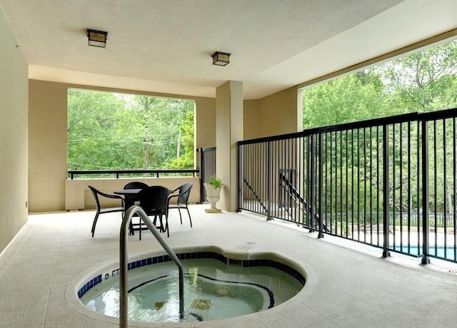 view of swimming pool with an indoor hot tub