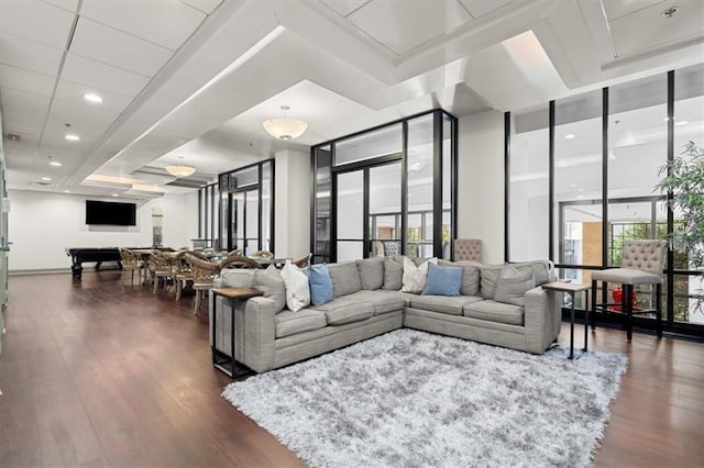 living room featuring dark hardwood / wood-style flooring and floor to ceiling windows