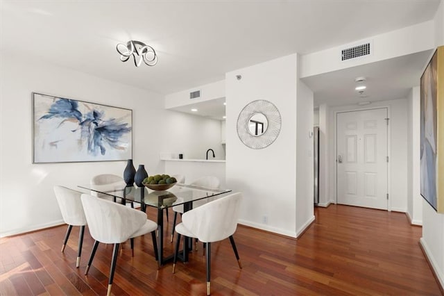 dining room with dark hardwood / wood-style flooring