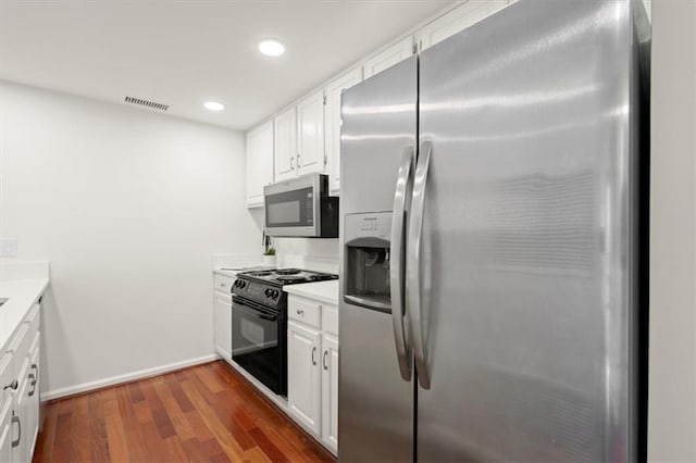 kitchen with dark hardwood / wood-style floors, white cabinetry, and appliances with stainless steel finishes