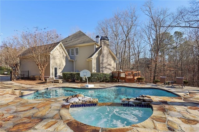 view of pool featuring an in ground hot tub, a deck, and a patio