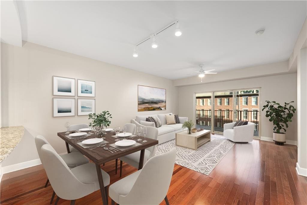 dining space featuring ceiling fan, track lighting, and hardwood / wood-style flooring