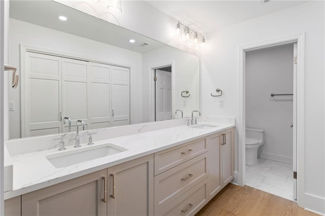 bathroom featuring vanity and toilet