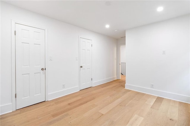 spare room featuring light wood-type flooring