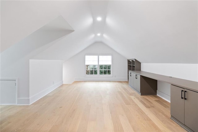 additional living space with lofted ceiling and light wood-type flooring