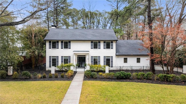 colonial home with a front lawn