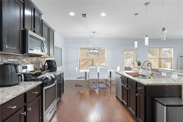2040 Harvest Ridge Cir, Buford, GA 30519 - kitchen featuring stainless steel appliances, a sink, dark wood-style floors, backsplash, and baseboards