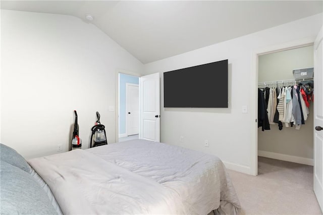 2040 Harvest Ridge Cir, Buford, GA 30519 - bedroom with a spacious closet, vaulted ceiling, a closet, light colored carpet, and baseboards