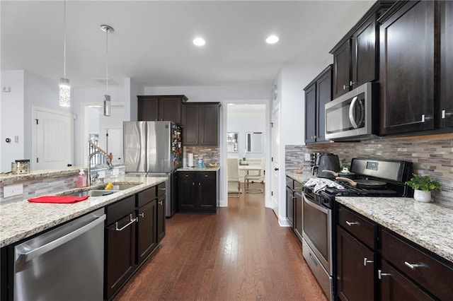 2040 Harvest Ridge Cir, Buford, GA 30519 - kitchen featuring stainless steel appliances, a sink, dark wood-type flooring, backsplash, and dark brown cabinetry