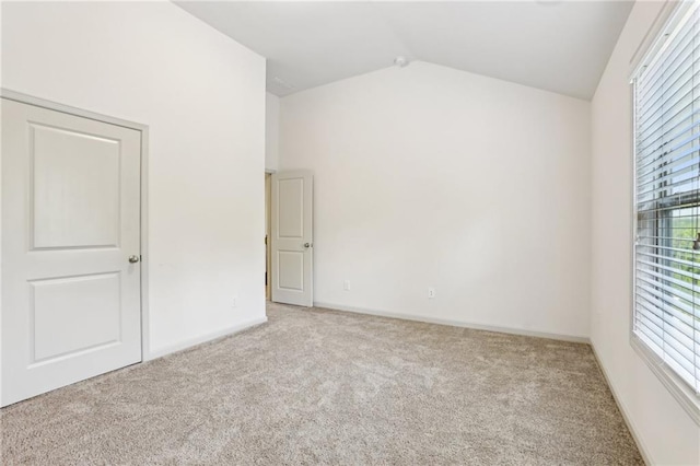 4459 Sierra Creek Dr, Hoschton, GA 30548 - empty room featuring a wealth of natural light, baseboards, lofted ceiling, and carpet