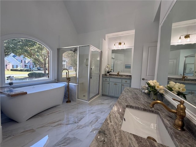 bathroom with shower with separate bathtub, vanity, and lofted ceiling