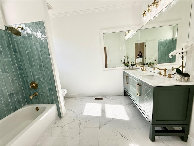 full bathroom with vanity, tiled shower / bath, ornamental molding, and toilet