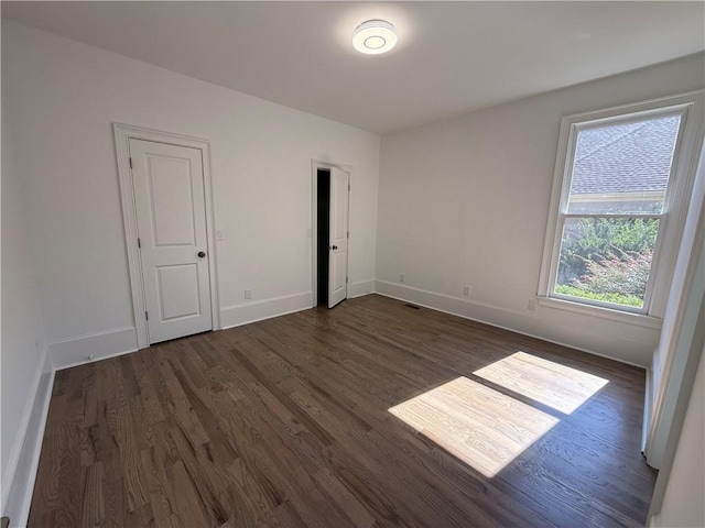 spare room featuring dark hardwood / wood-style flooring