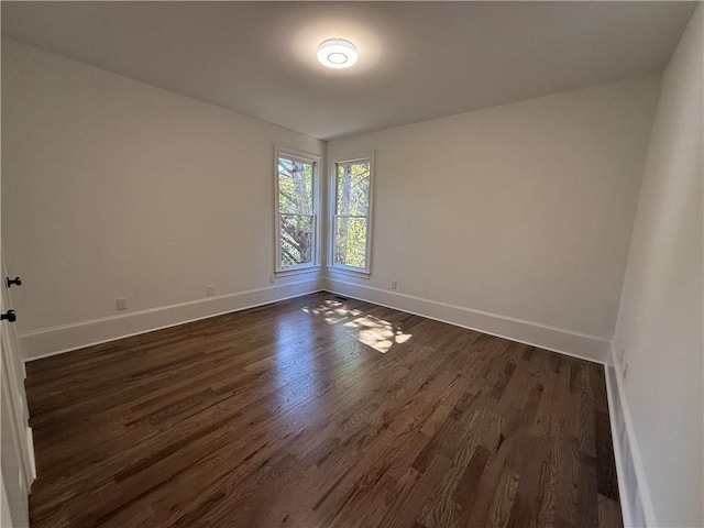 unfurnished room with dark hardwood / wood-style floors