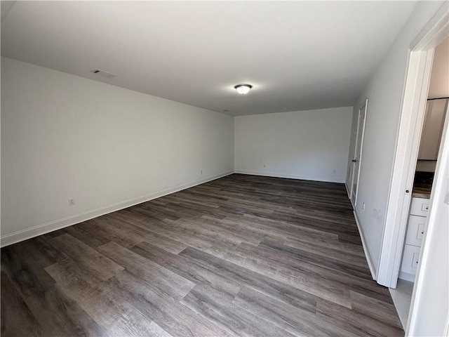 spare room featuring dark hardwood / wood-style flooring