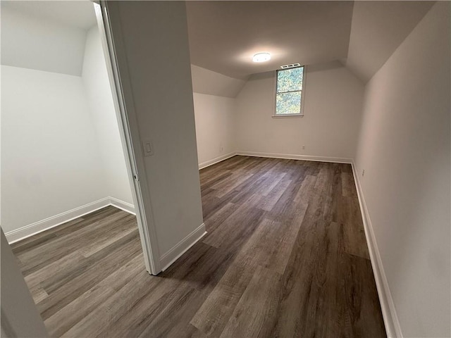 bonus room featuring lofted ceiling and dark wood-type flooring