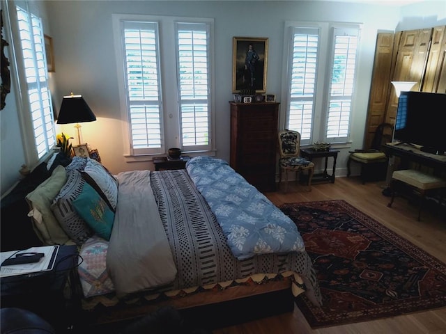 3655 Peachtree Rd Unit 203, Atlanta, GA 30319 - bedroom featuring multiple windows and wood finished floors