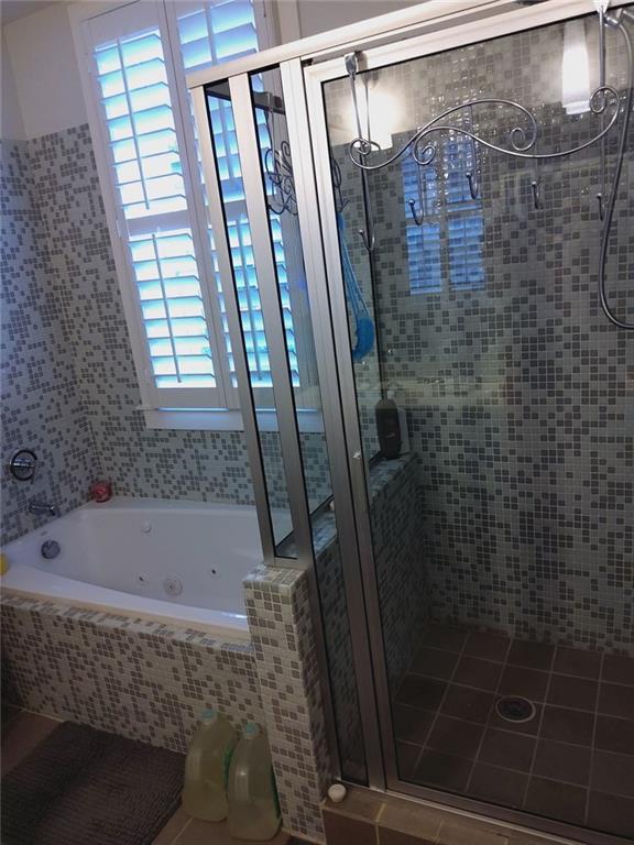 3655 Peachtree Rd Unit 203, Atlanta, GA 30319 - bathroom featuring a stall shower and a tub with jets
