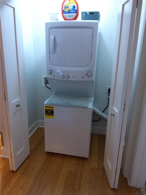 3655 Peachtree Rd Unit 203, Atlanta, GA 30319 - washroom with stacked washer / dryer and light wood-type flooring