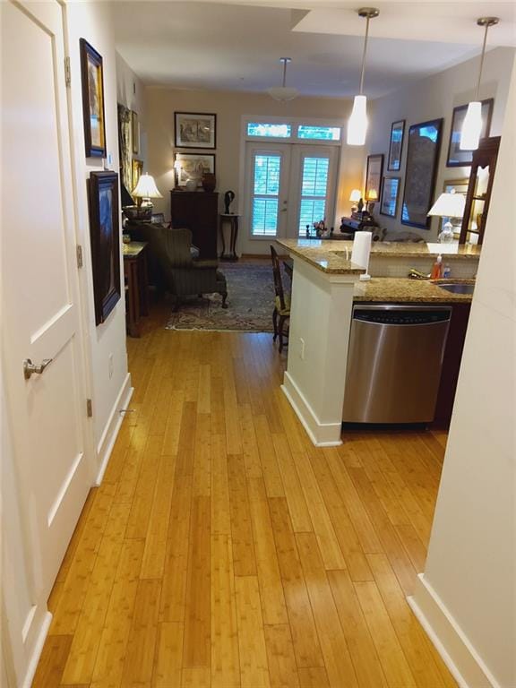 3655 Peachtree Rd Unit 203, Atlanta, GA 30319 - kitchen with stainless steel dishwasher, light wood-style floors, open floor plan, and decorative light fixtures