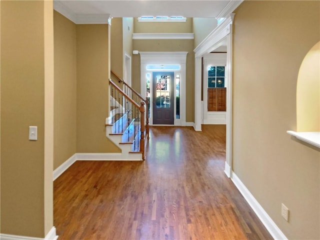 entryway featuring crown molding and hardwood / wood-style floors