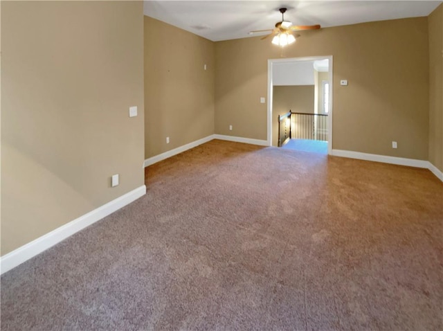 carpeted spare room with ceiling fan