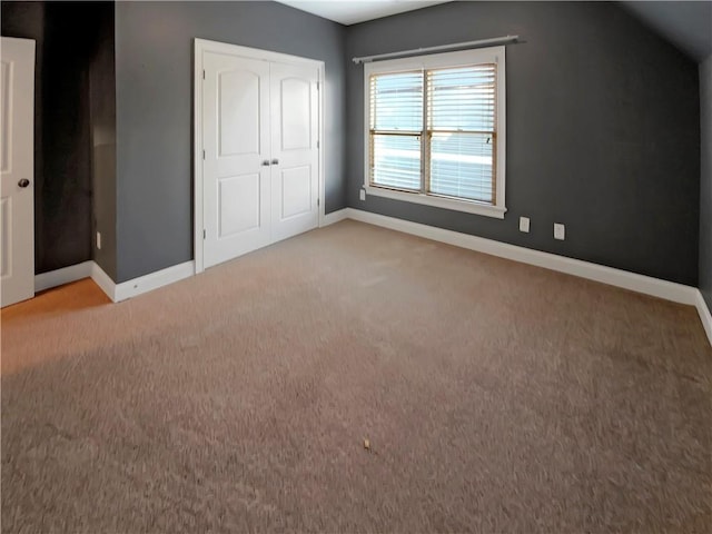 bonus room featuring light carpet and vaulted ceiling