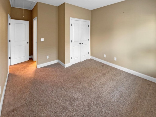 unfurnished bedroom with carpet flooring and a closet