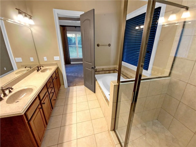 bathroom featuring tile patterned flooring, vanity, and shower with separate bathtub