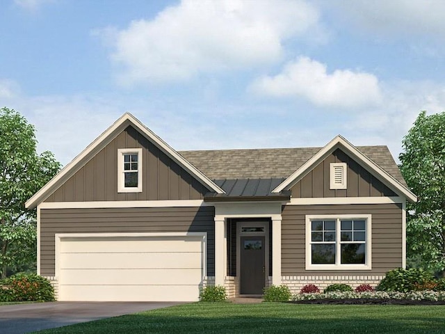 view of front of home with a garage and a front lawn