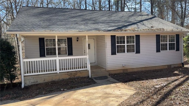 view of front of property featuring covered porch, a shingled roof, and crawl space