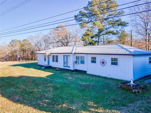 view of front of home with metal roof, a front lawn, and cooling unit