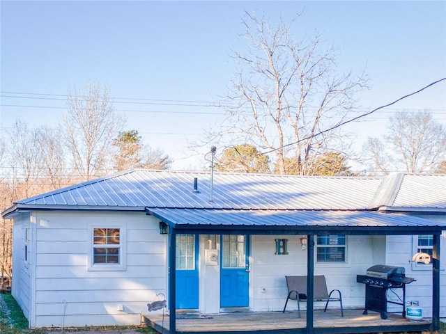 rear view of house with metal roof and a porch