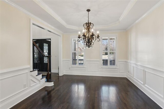 kitchen featuring dark stone countertops, backsplash, dark hardwood / wood-style floors, ornamental molding, and stainless steel appliances