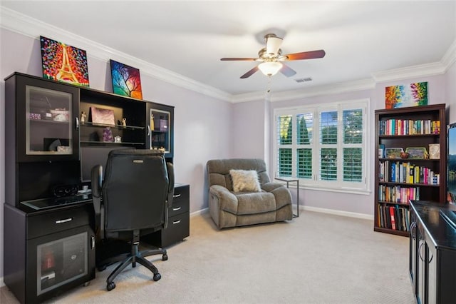 home office with a ceiling fan, light colored carpet, crown molding, and baseboards