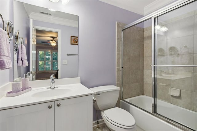 full bathroom with toilet, crown molding, shower / bath combination with glass door, vanity, and ceiling fan