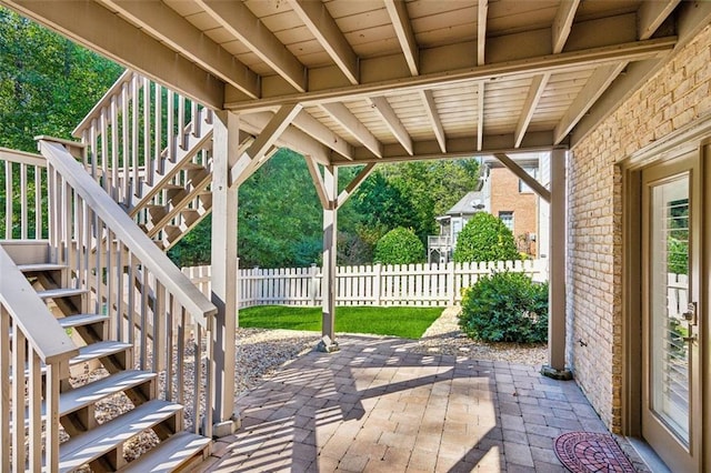 view of patio / terrace with stairway and fence