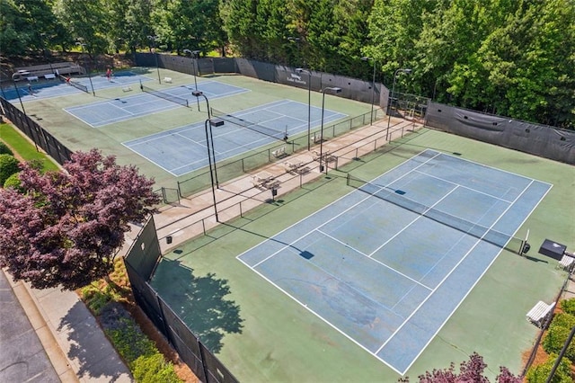 view of tennis court featuring fence