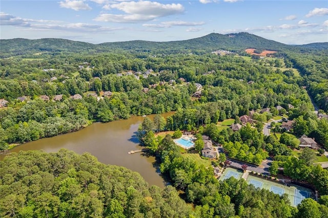 bird's eye view featuring a view of trees and a water and mountain view