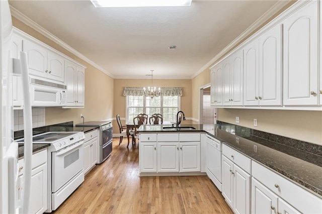656 Deerwood Way, Evans, GA 30809 - kitchen featuring white appliances, a sink, a chandelier, a peninsula, and white cabinetry