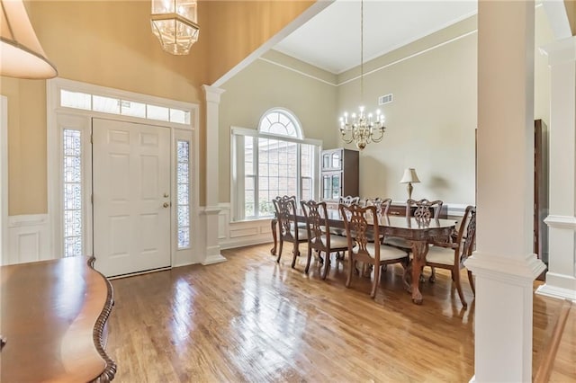 656 Deerwood Way, Evans, GA 30809 - entryway featuring a high ceiling, a chandelier, light wood-style flooring, a decorative wall, and wainscoting